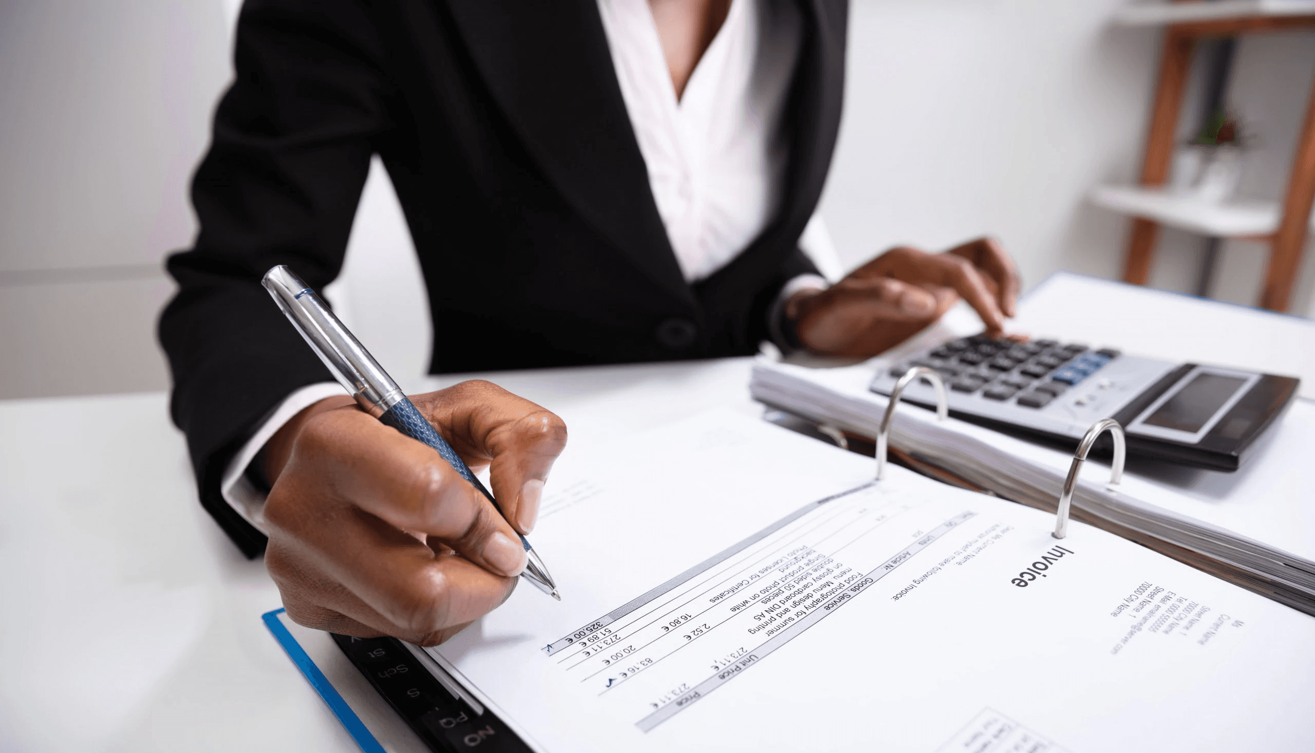 Man reviewing financial invoice documents - How to Invoice as a Freelancer